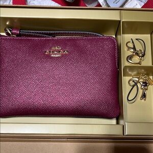 Coach Women's Magenta Wristlet with two Charms NIB.